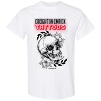 a white t - shirt with an image of a skull and flowers
